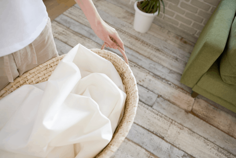 laundry basket with white towel inside