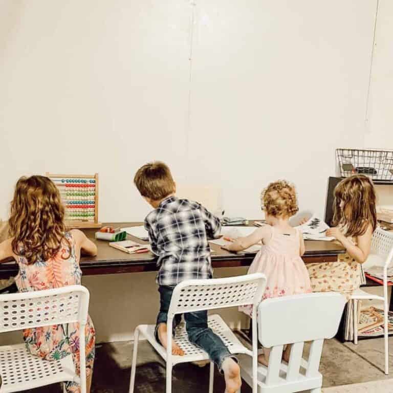 children sitting at table in classroom