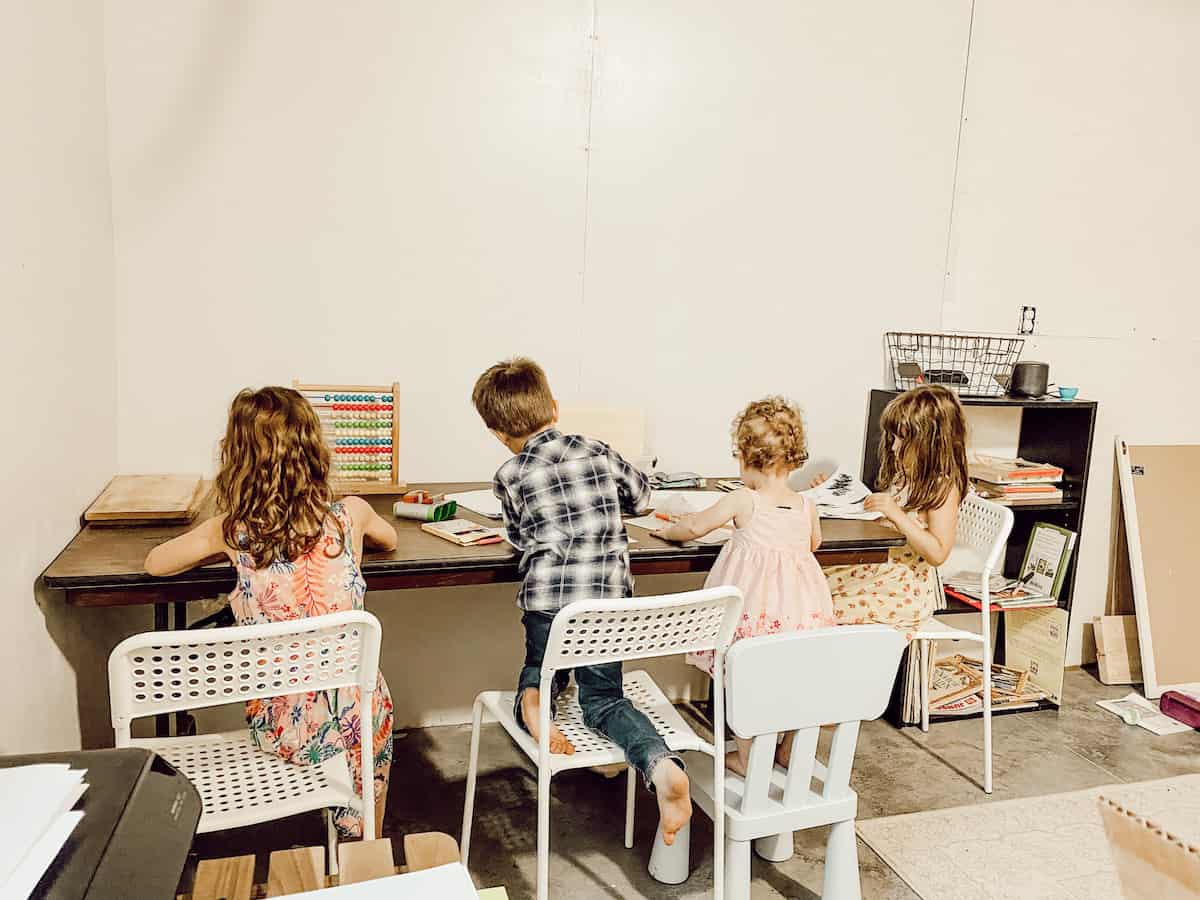 children sitting at table in classroom 