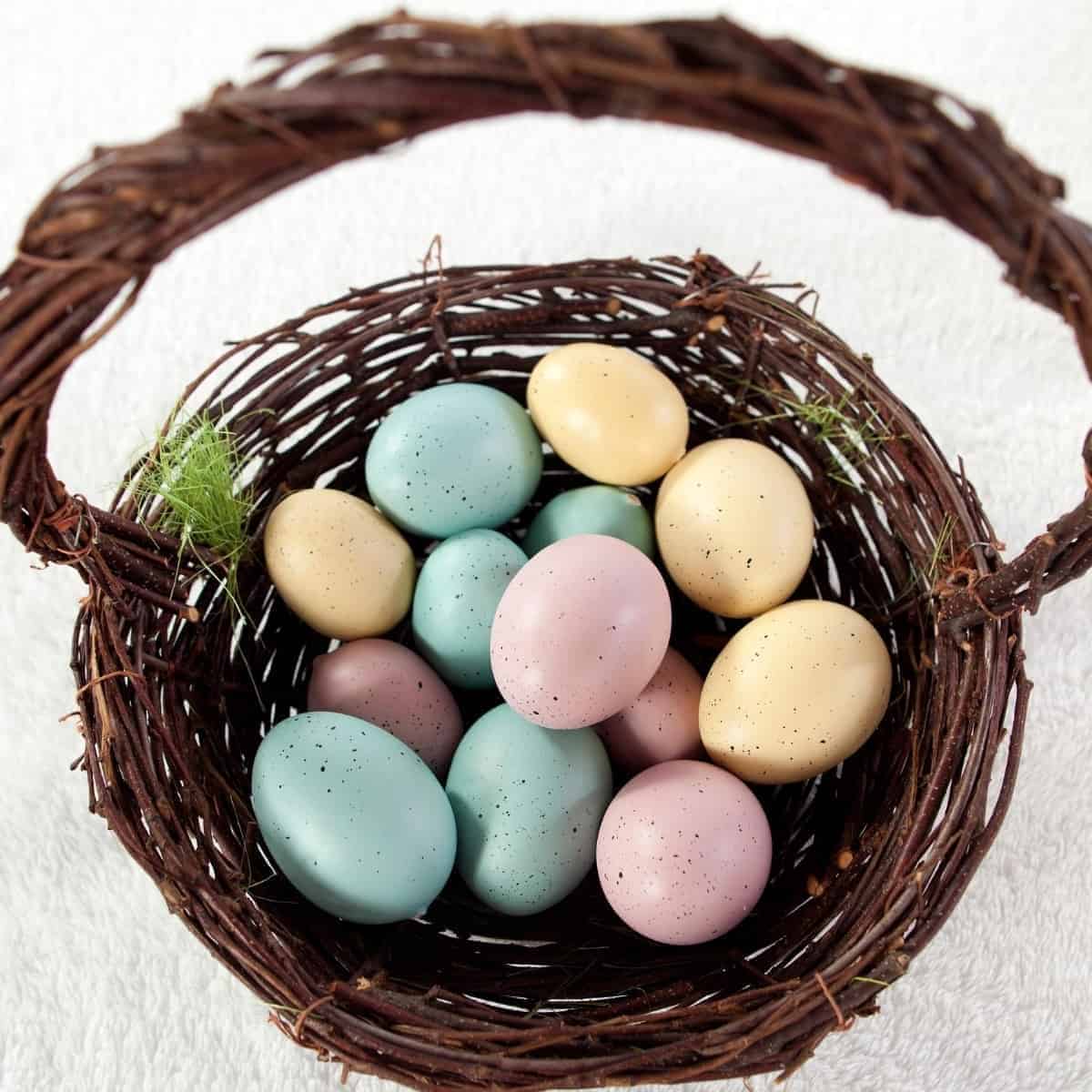 brown wicker natural easter basket filled with colorful eggs