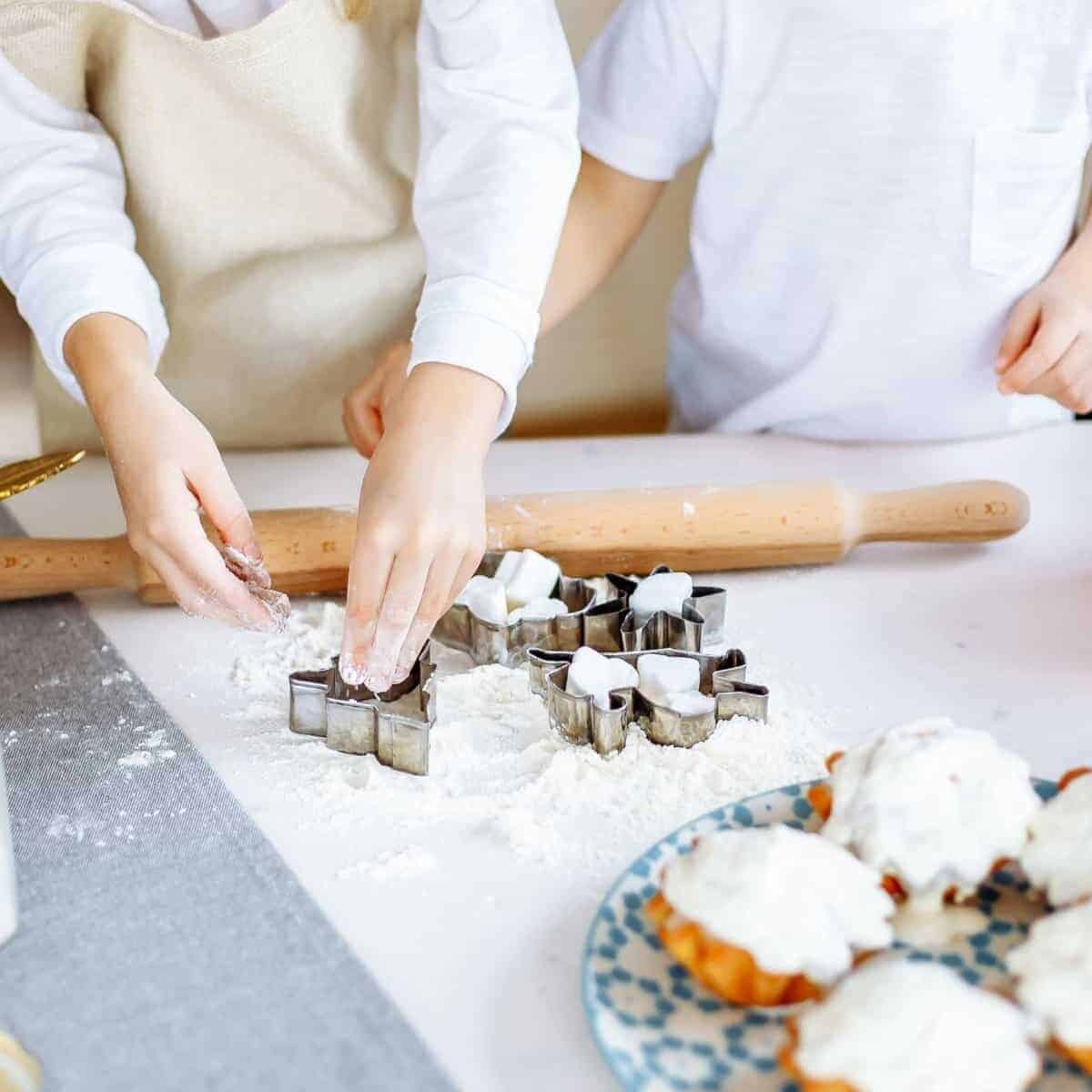 kids baking christmas cookies in the kitchen