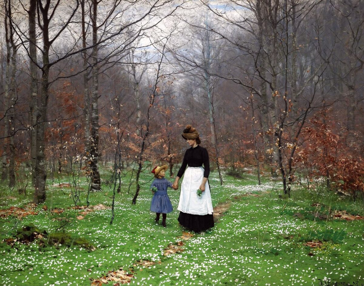 Mother walking outside with a small child. 