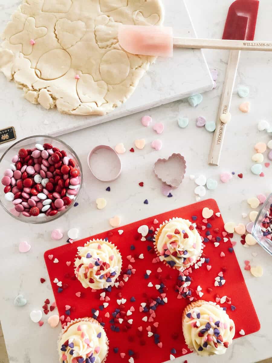 cupcakes and rolled out sugar cookies with cutters 