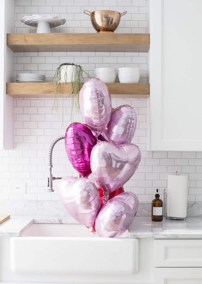 pink heart balloons by the kitchen sink