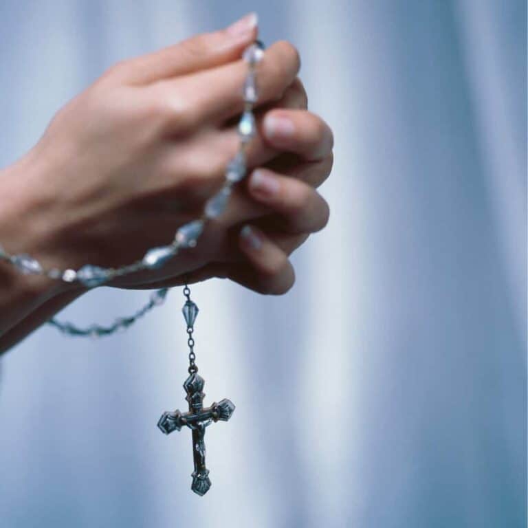 rosary in woman’s hands