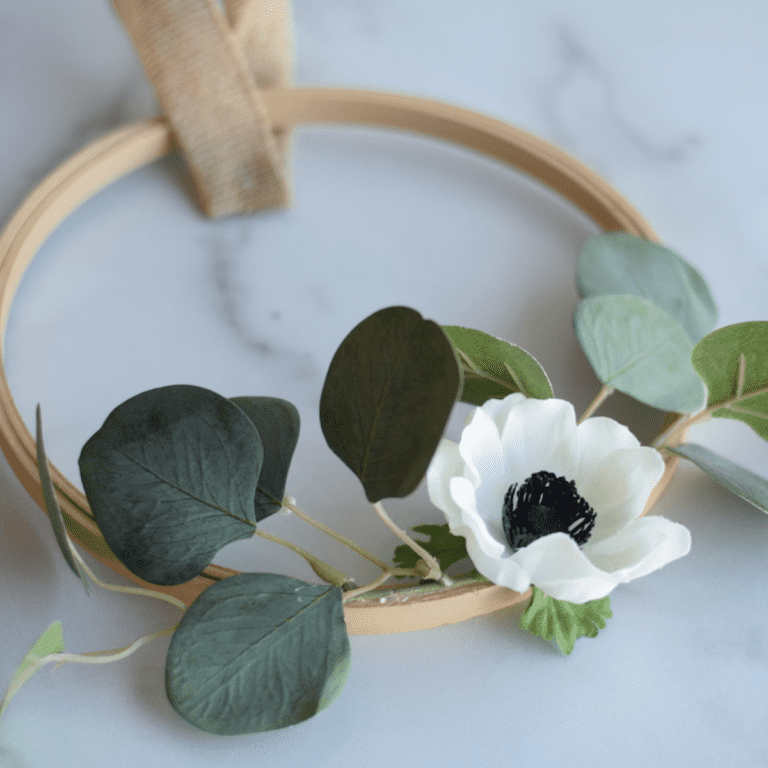 embroidery hoop made into a wreath with white poppy flower and eucalyptus greenery