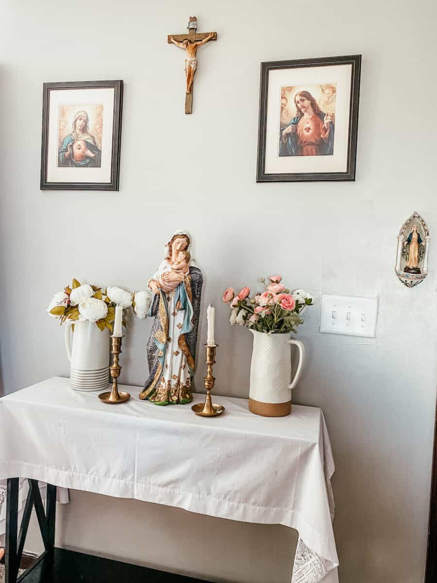 catholic family home altar set up with devotionals and holy images