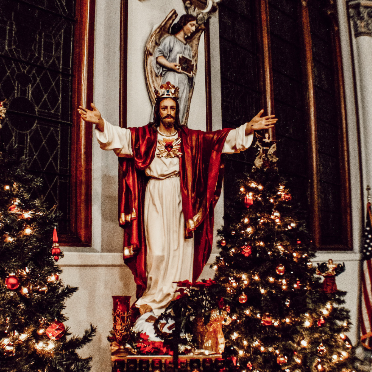 Sacred Heart of Jesus statue decorated at Christmas time inside of the Catholic Church.