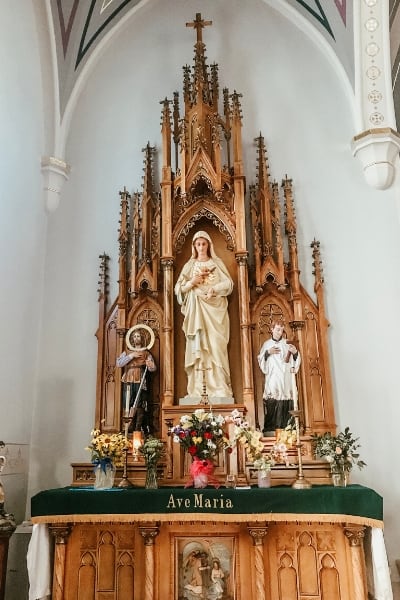 traditional catholic altar in church with Blessed Mother statue