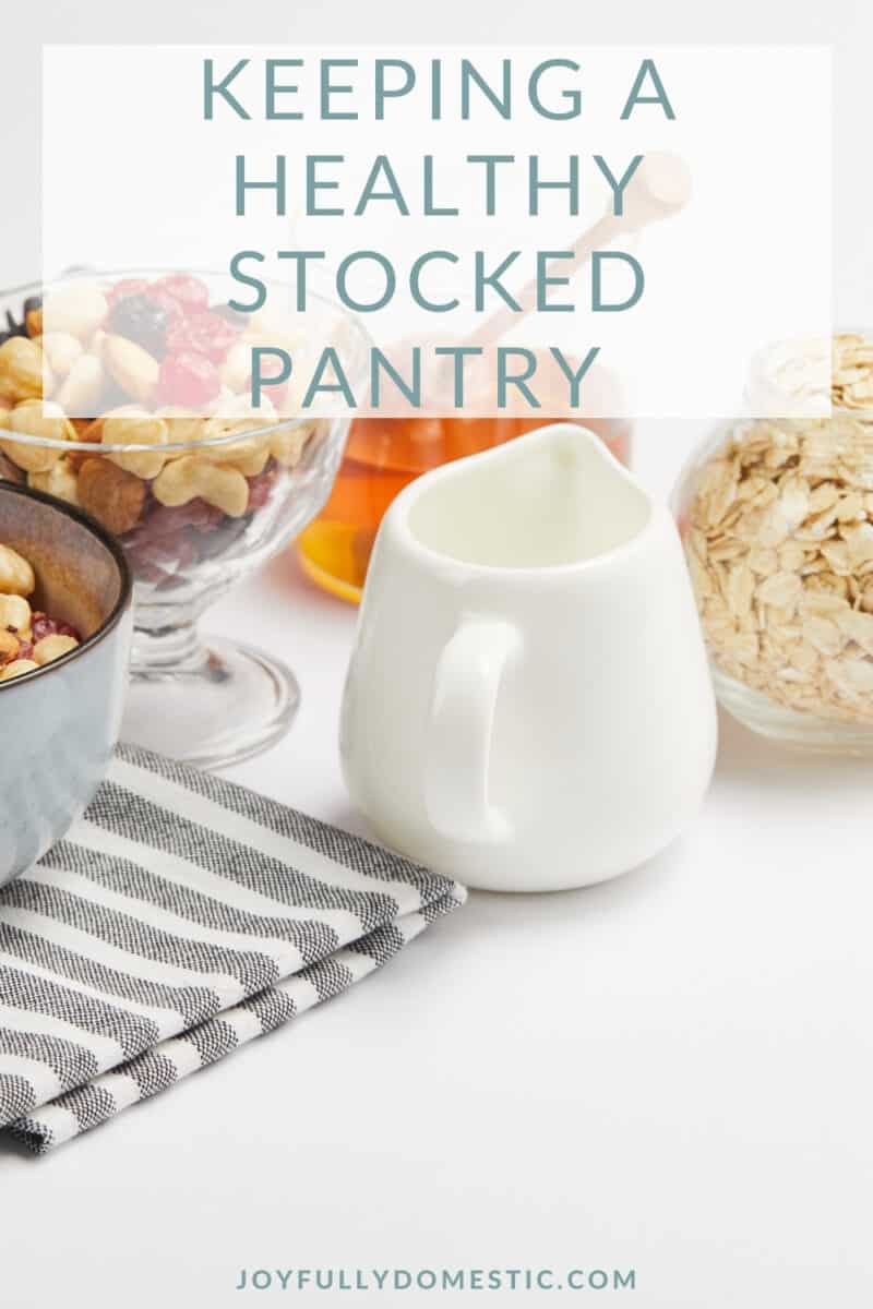 white creamer and bowls of dried fruits, oats, and honey
