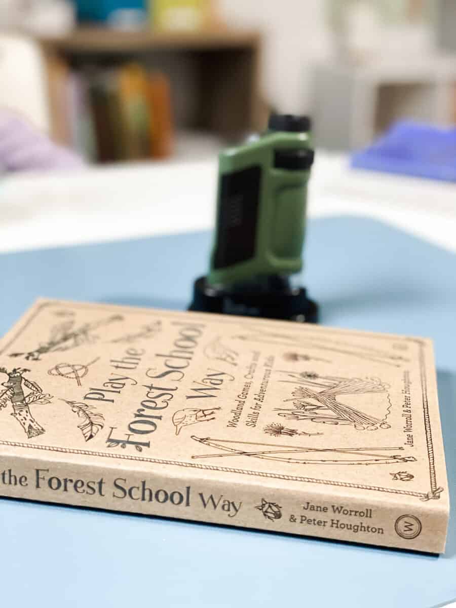 pocket microscope and nature study book on desk in classroom