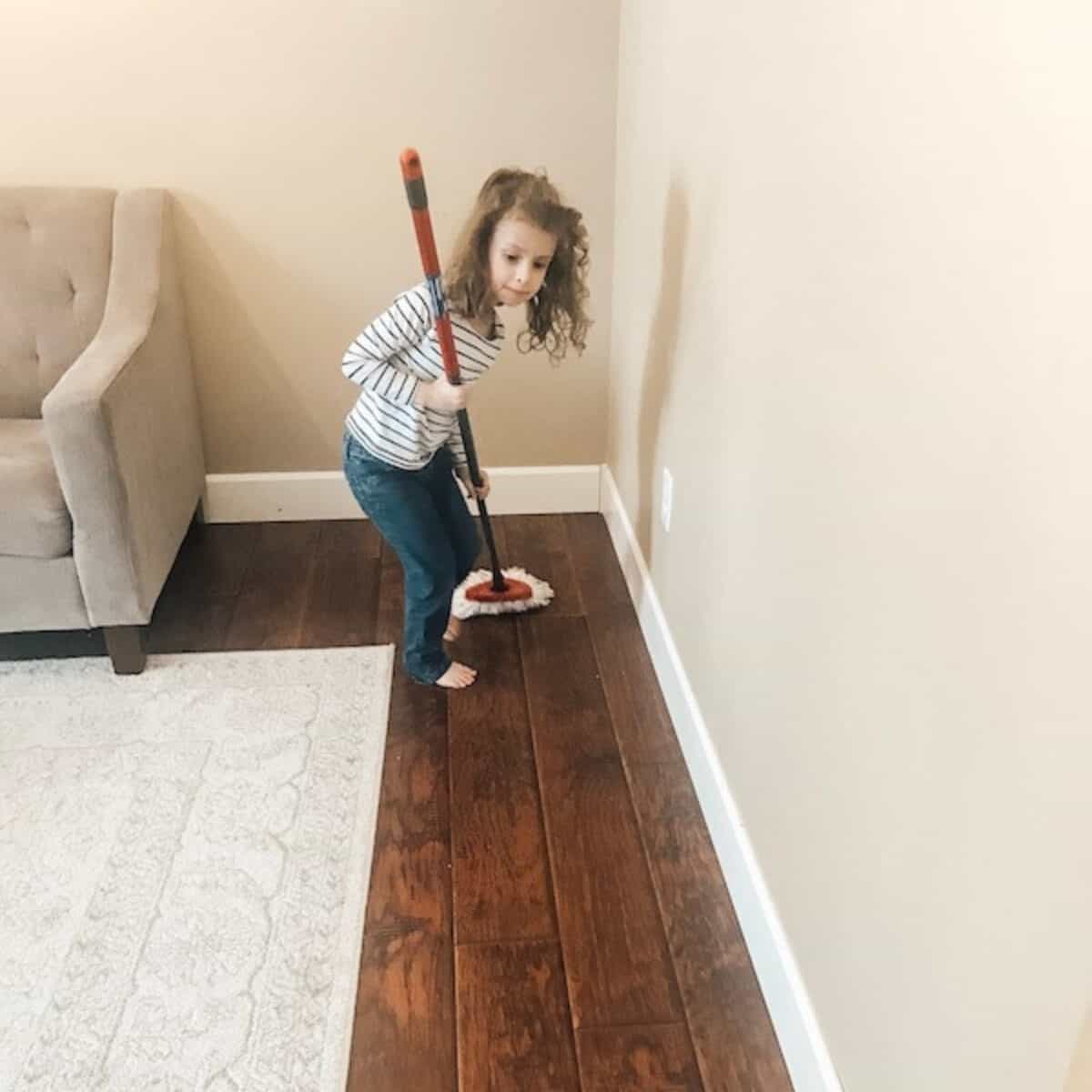 child cleaning the floors as part of daily chores