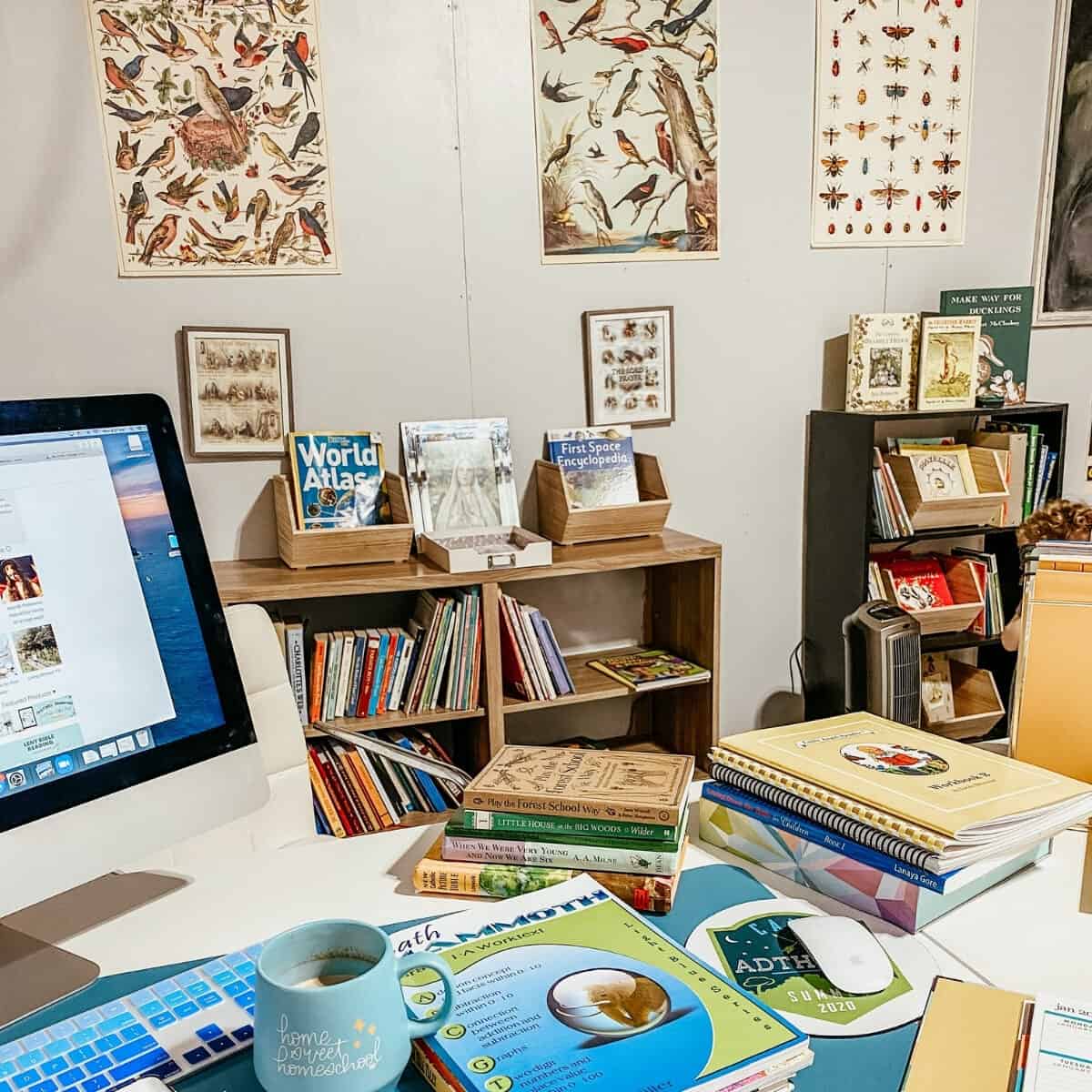 school desk piled with homeschool books and teacher planner 