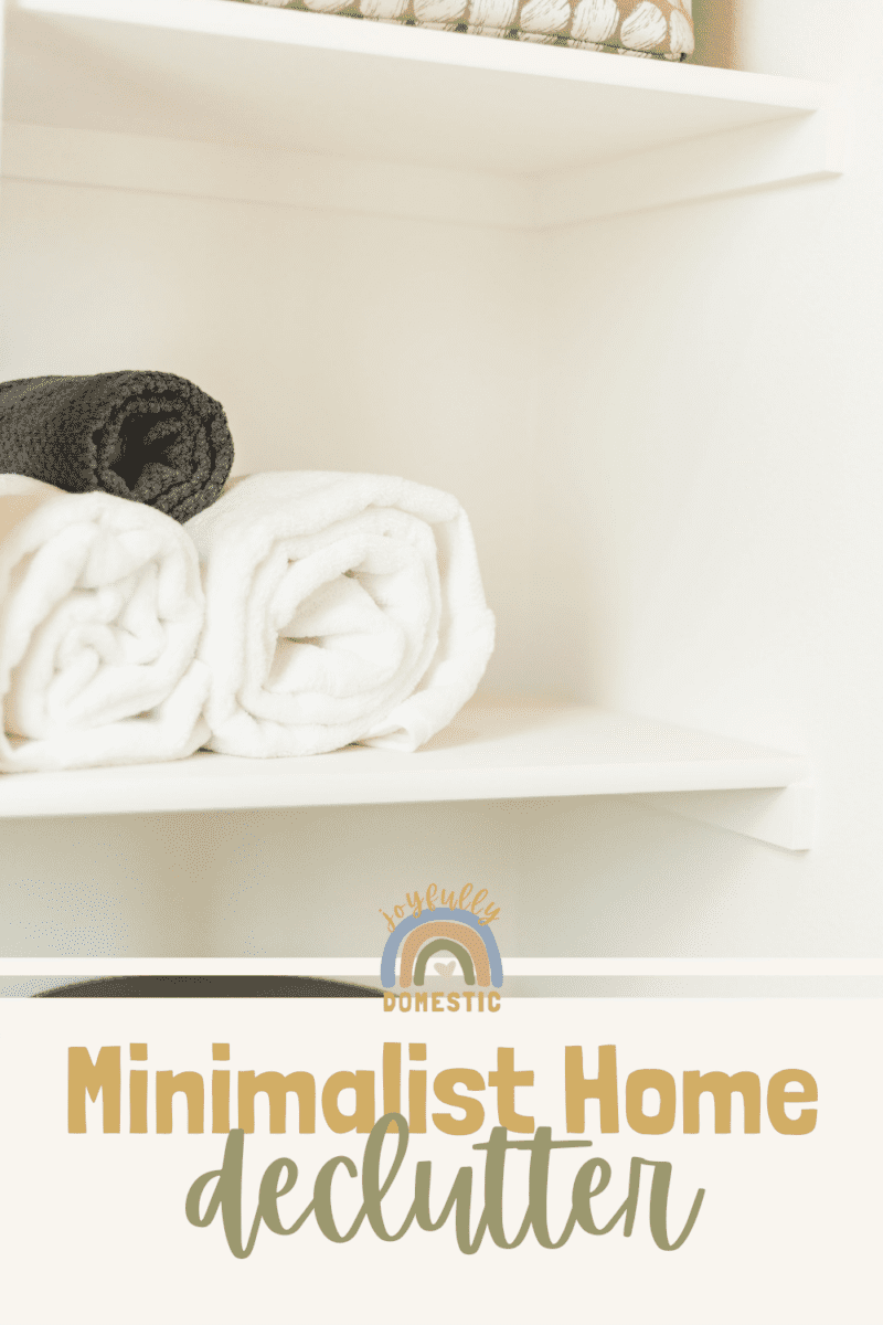 rolled white bath towels on a shelf in a closet