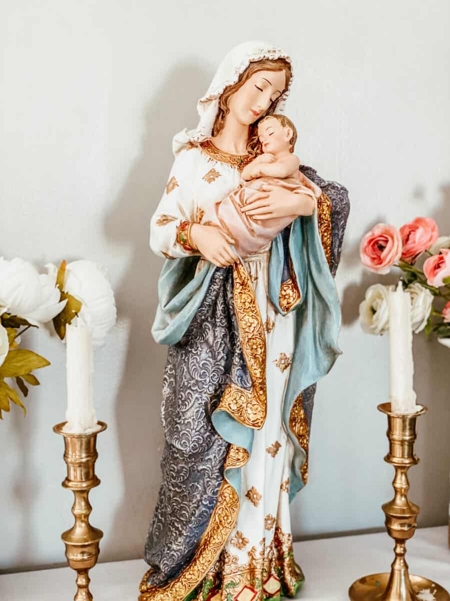 blessed mother statue with blessed candles to either side
