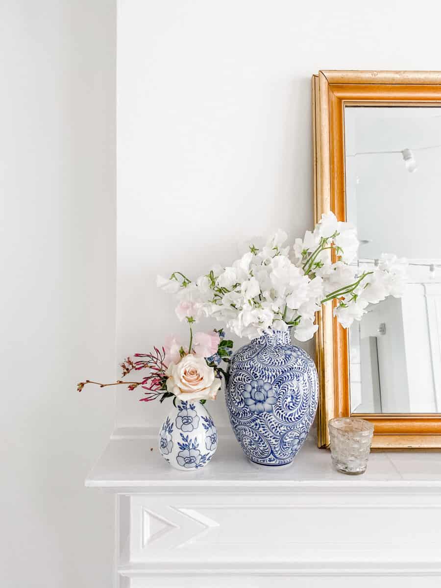 vase of flowers and mirror on mantel