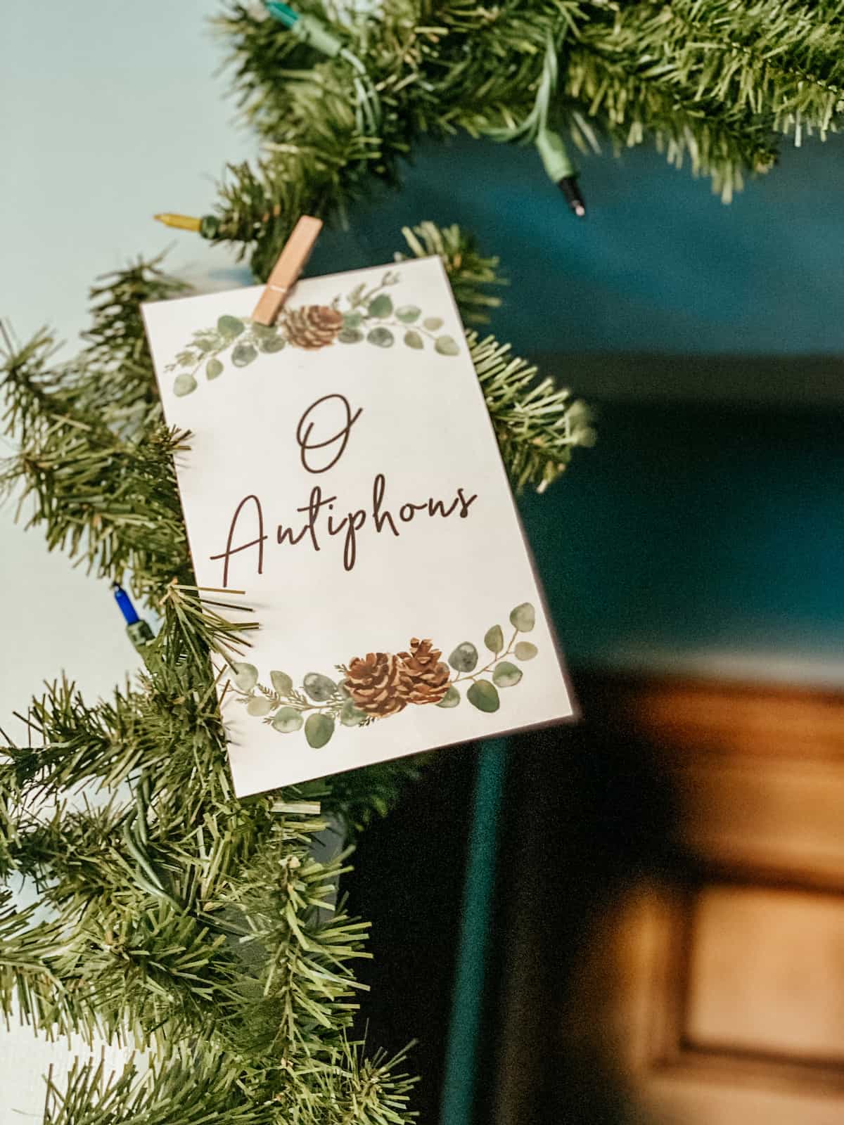 o antiphons card hanging on greenery around the doorway. 