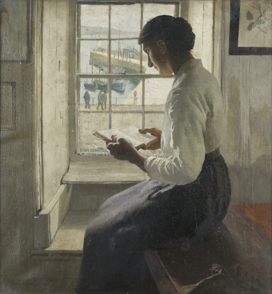 a lady reading a book while sitting by the window. 