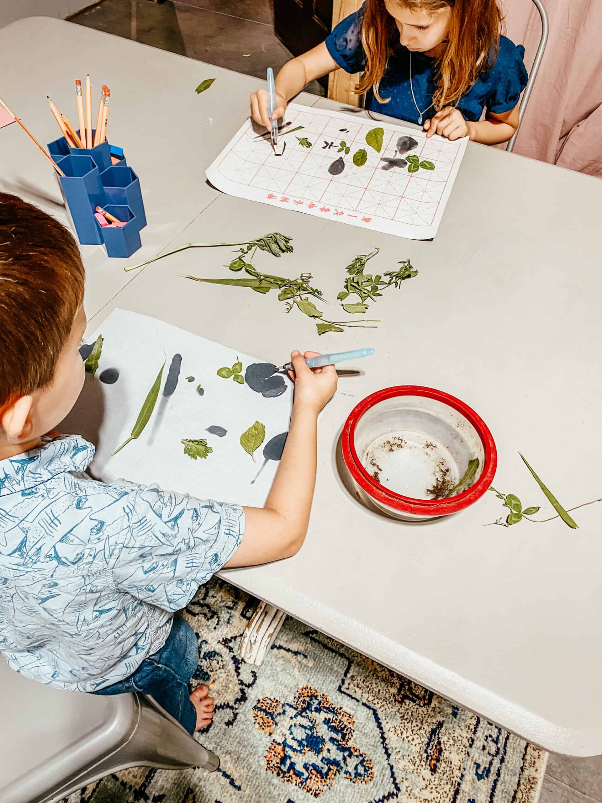 children brush drawing in the classroom.