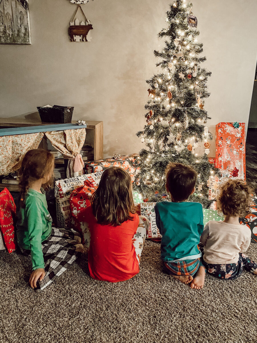 children under the Christmas tree on Christmas morning.