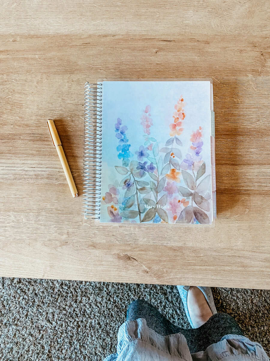 planner with a pen resting on a table.