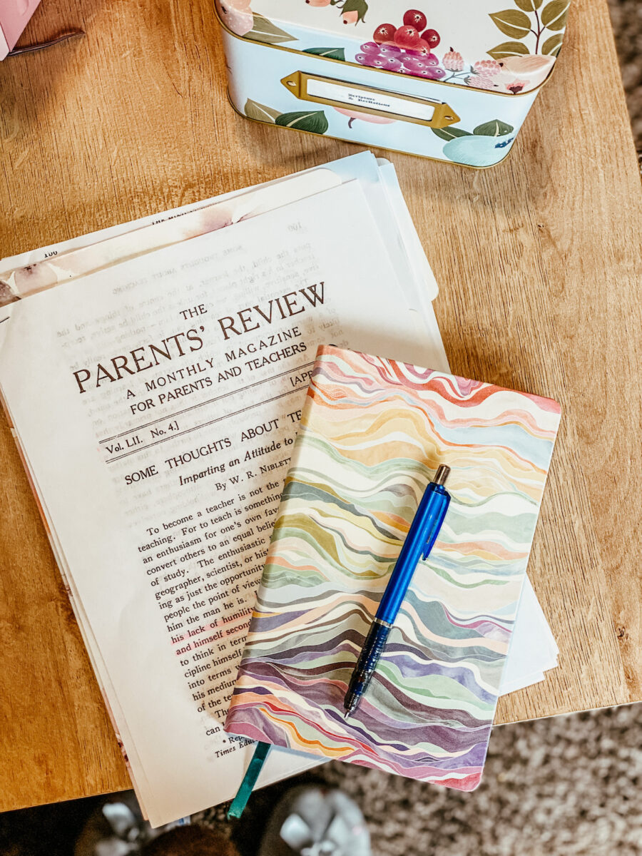 parent’s review article with a colorful notebook and blue pencil resting on top.