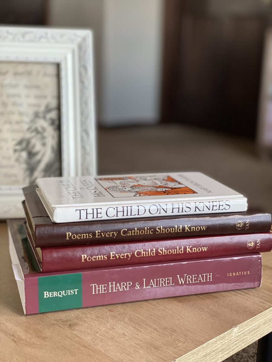 catholic poetry books stacked on the table. 