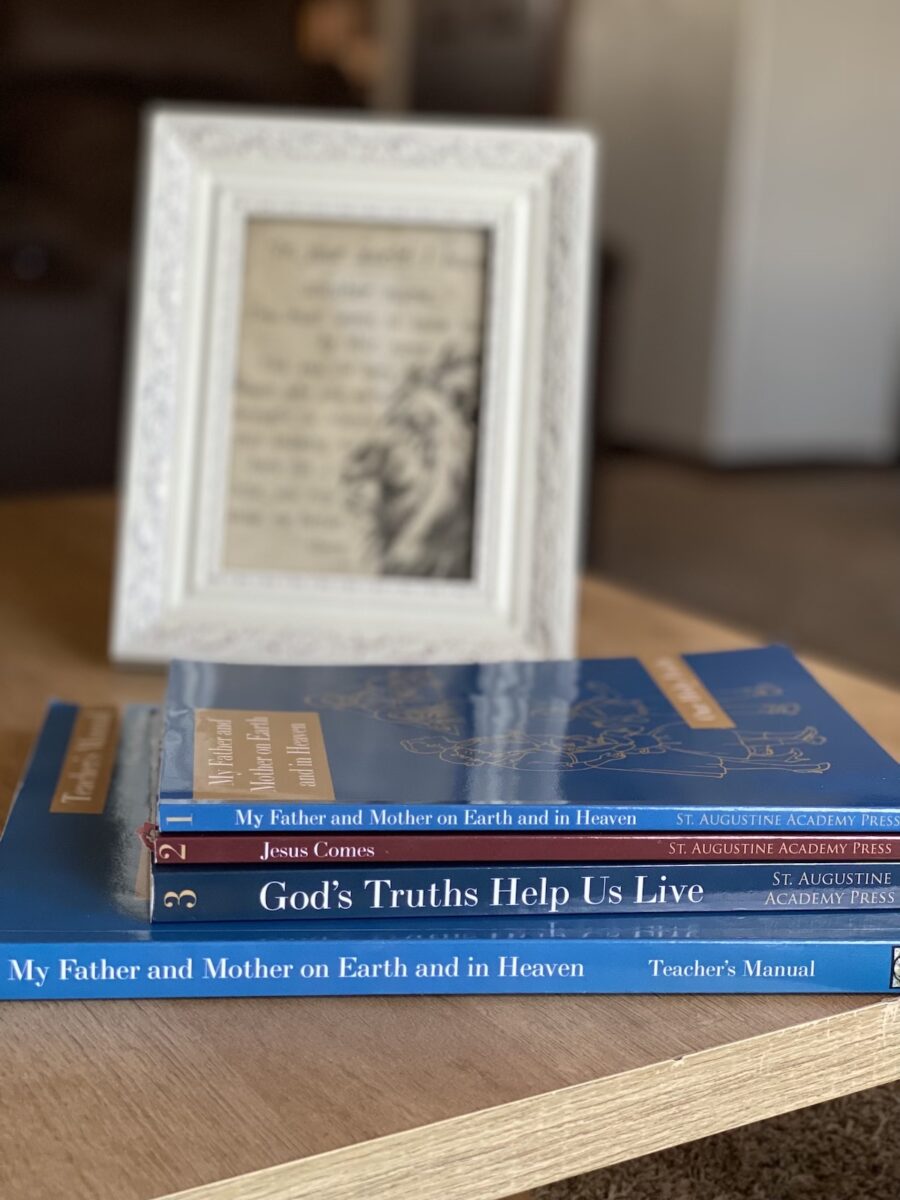 catechism books stacked on a table.