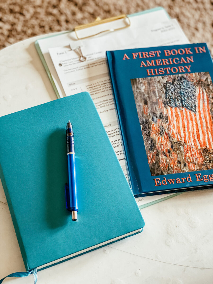 notebook used for pre-reading and a elementary history book on the table.