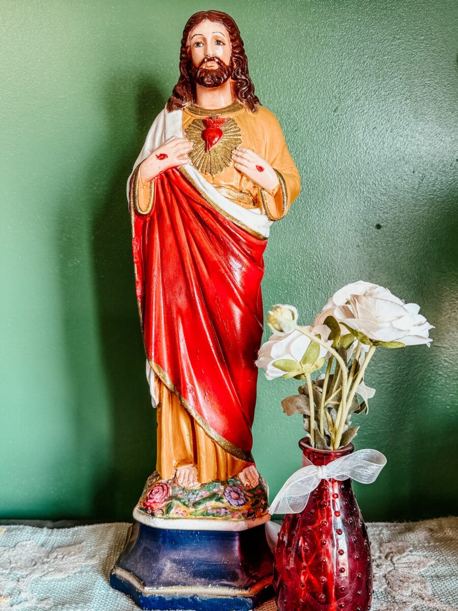 statue of the Sacred Heart of Jesus on a shelf.