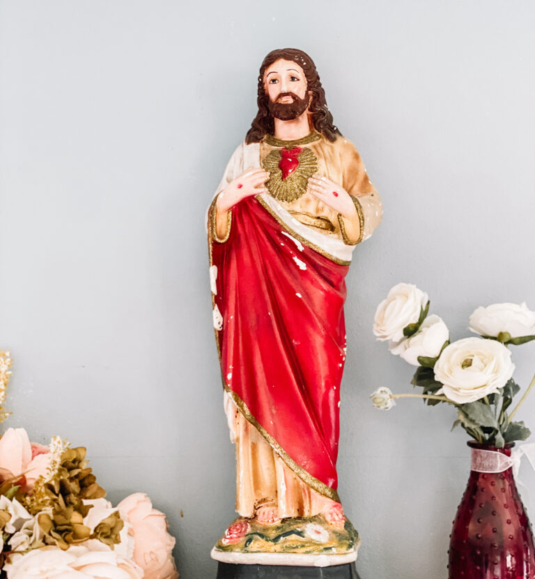 statue of the Sacred Heart of Jesus on a shelf.