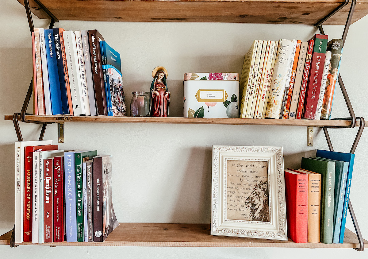 school books on a shelf with decor & picture frame.