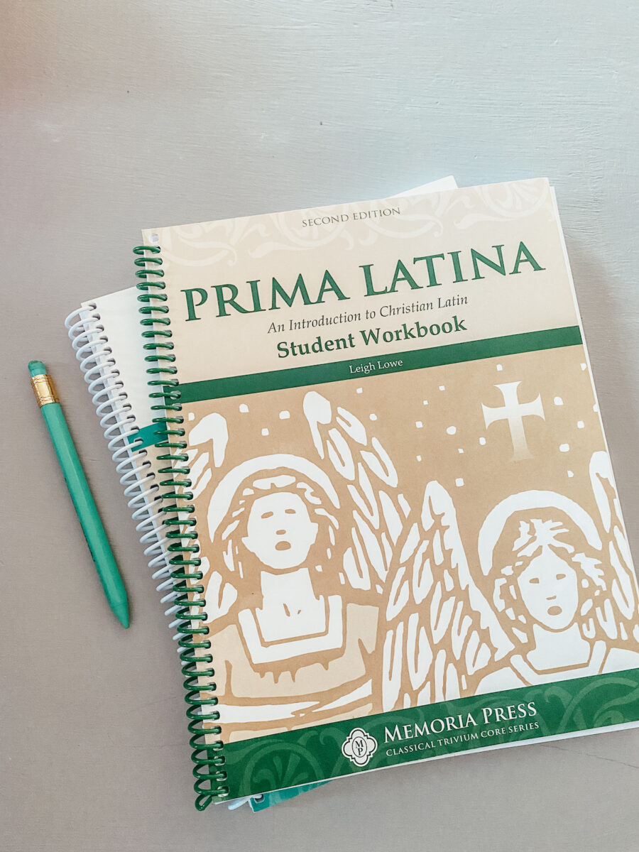 latin workbooks on a table. 