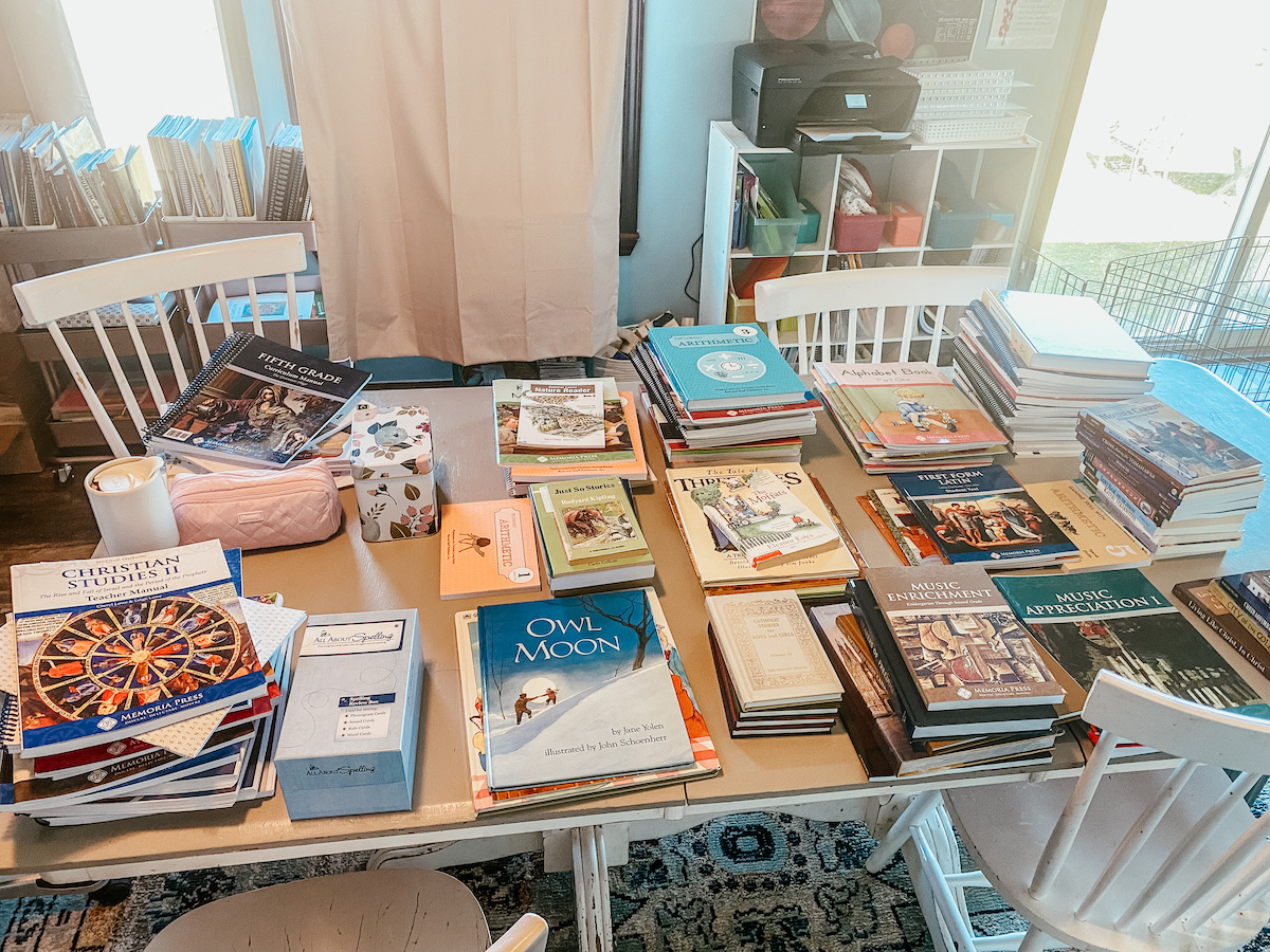 school books spread over the dining room table. 
