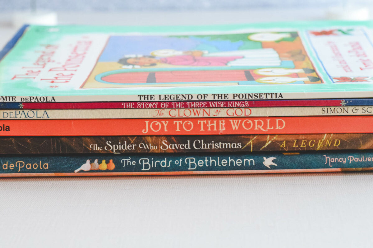 stack of Tomie dePaola Christmas picture books on a table top. 