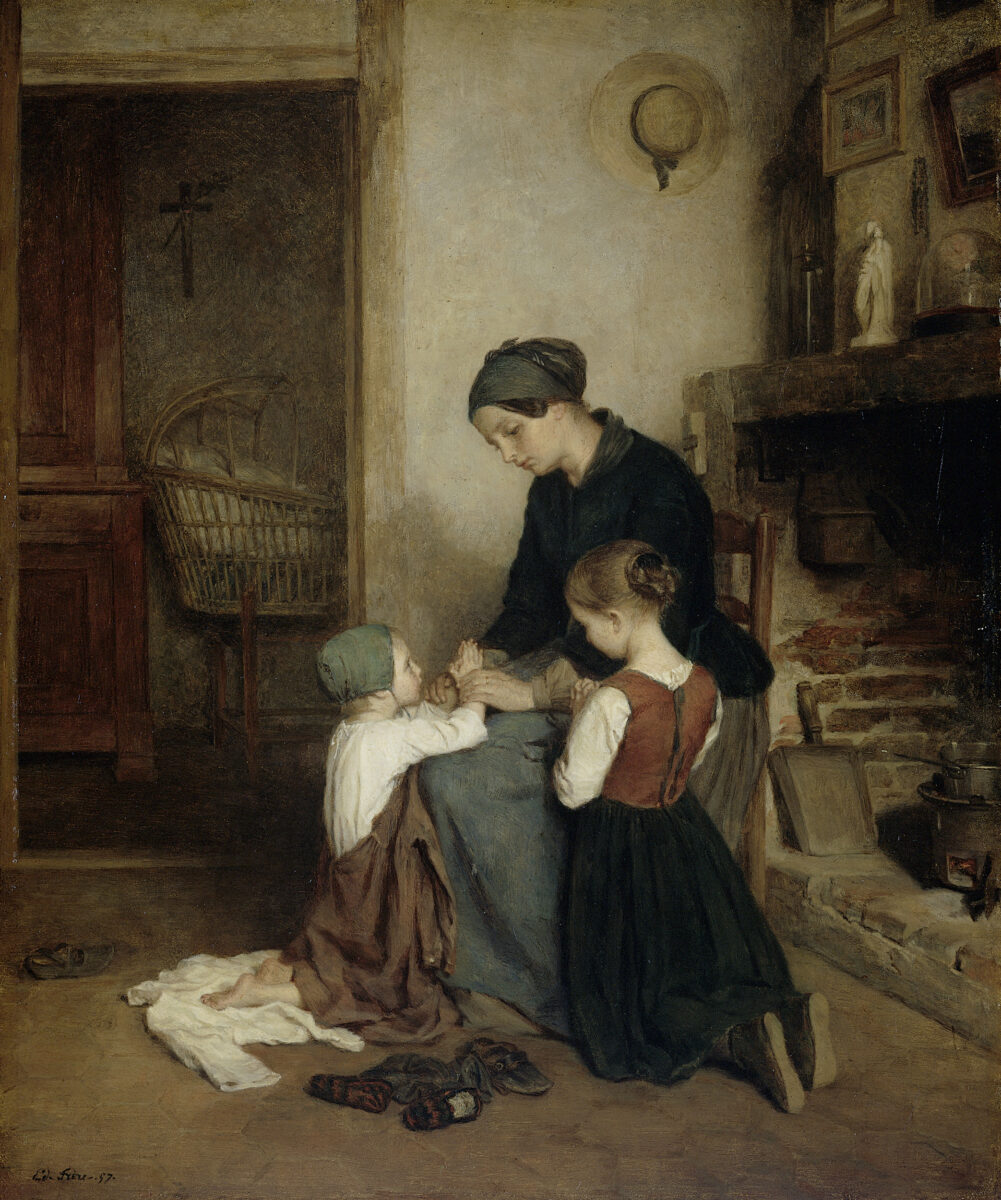 mother sitting and teaching prayers to small children.