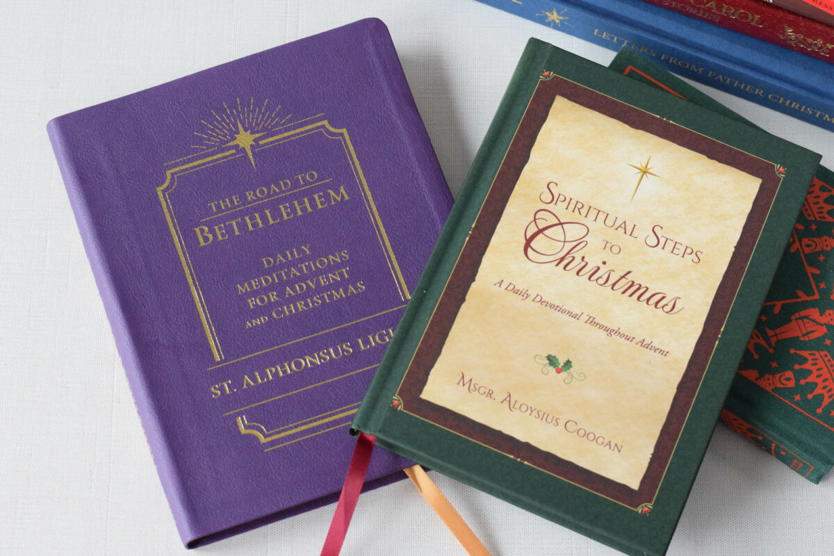 Advent and Christmas devotional books stacked on the table. 