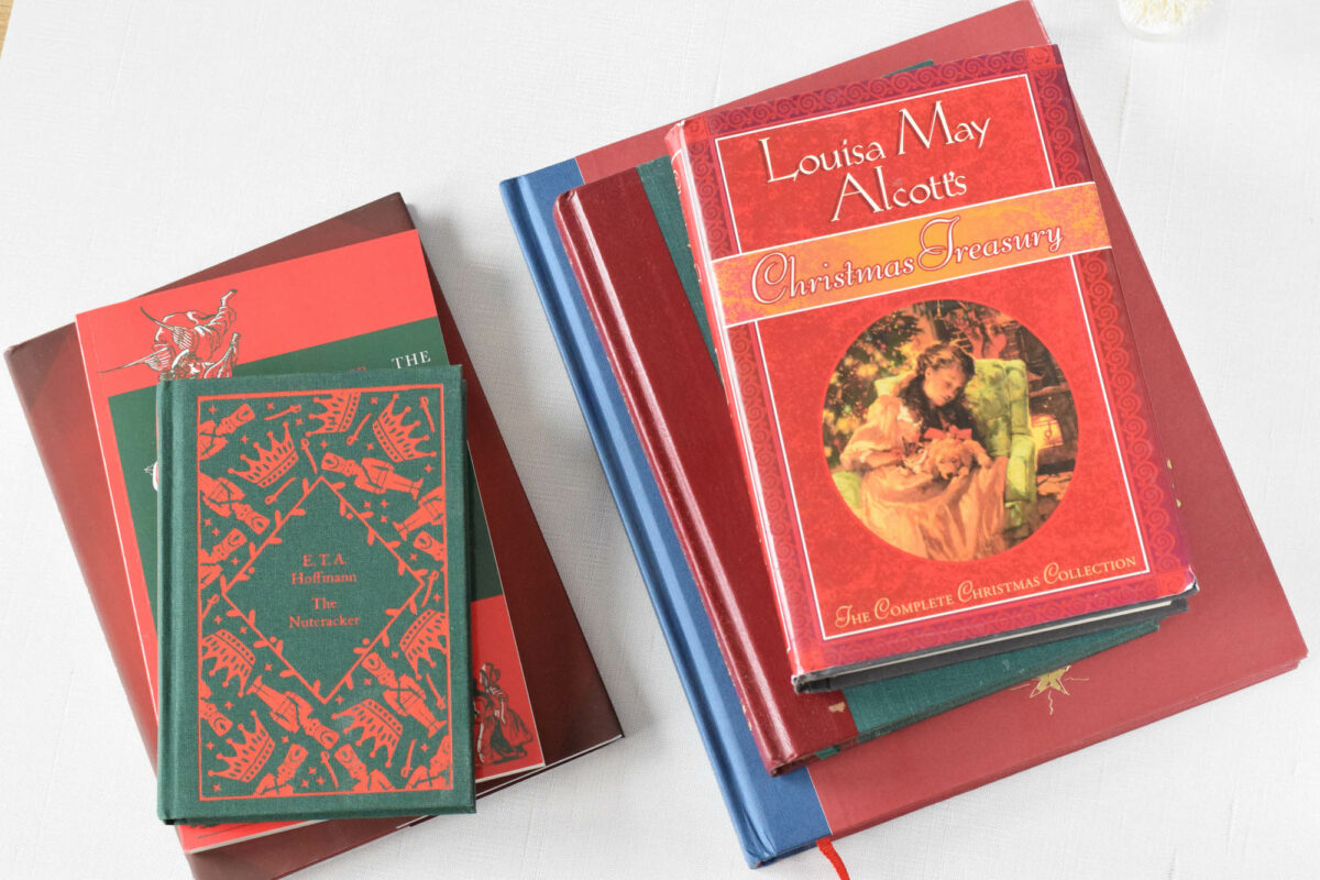 stack of christmas read aloud books on a table showing their covers.