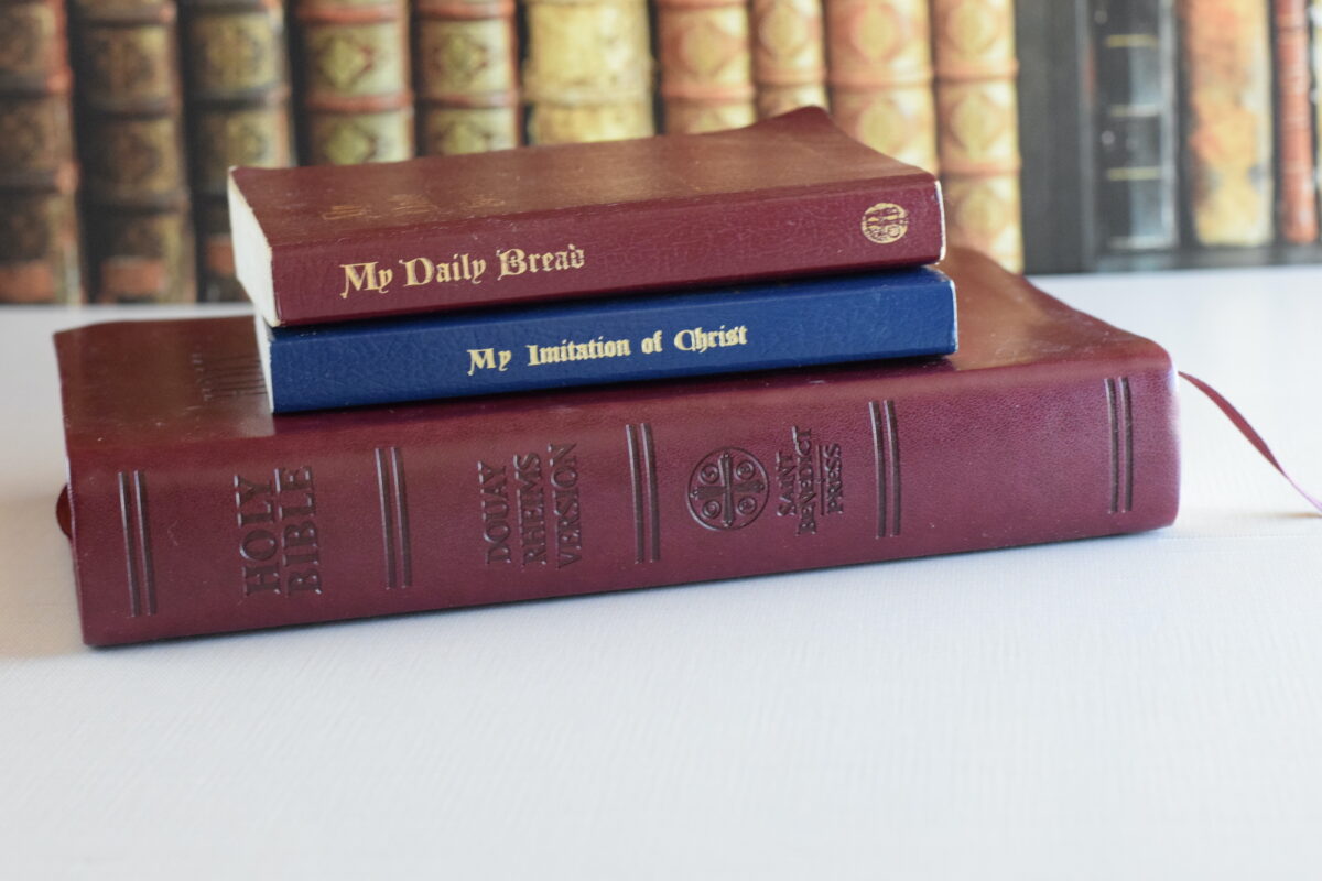 Holy bible and spiritual classic books on a table. 