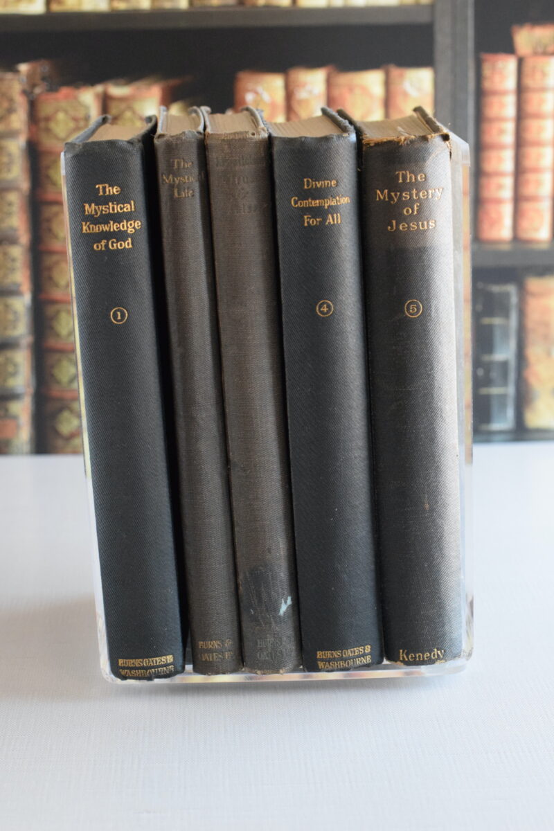 stack of vintage prayer books on a table.