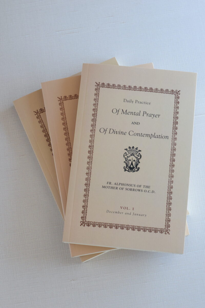 stack of vintage prayer books on a table.