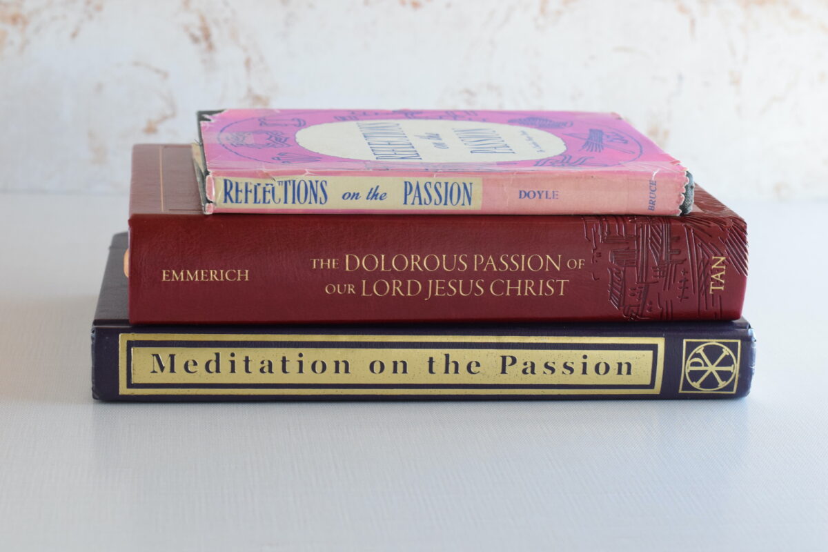 stack of vintage prayer books on a table.