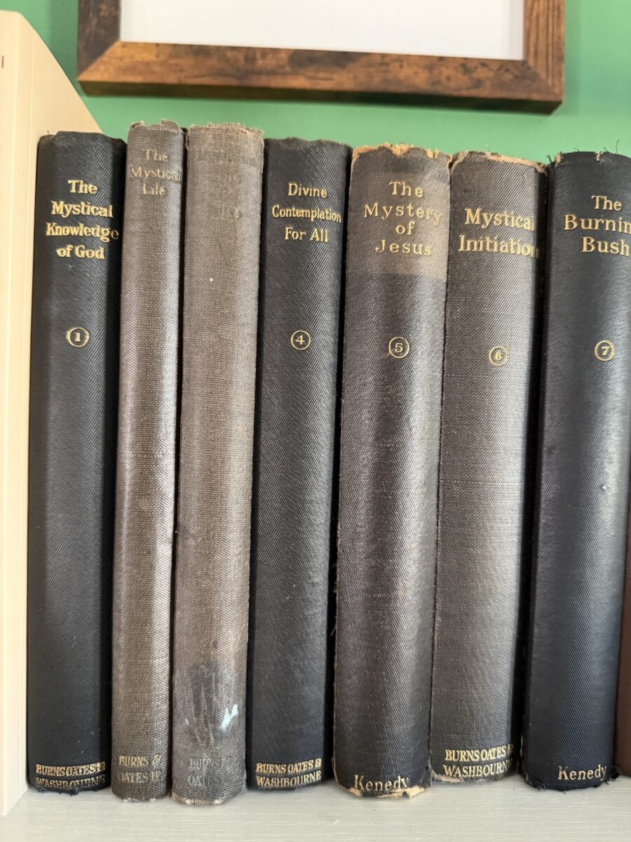 stack of vintage prayer books on a table.