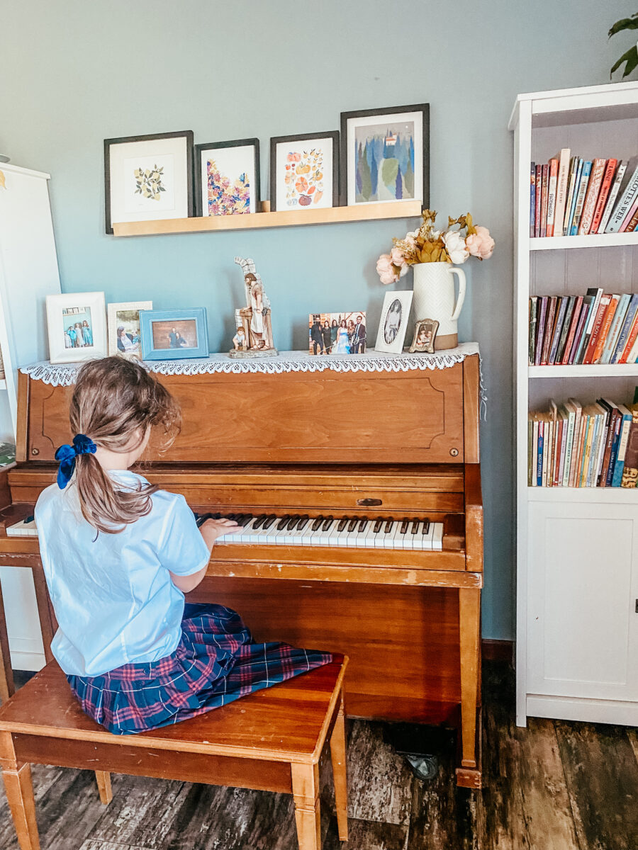 little girl playing the piano in the home.