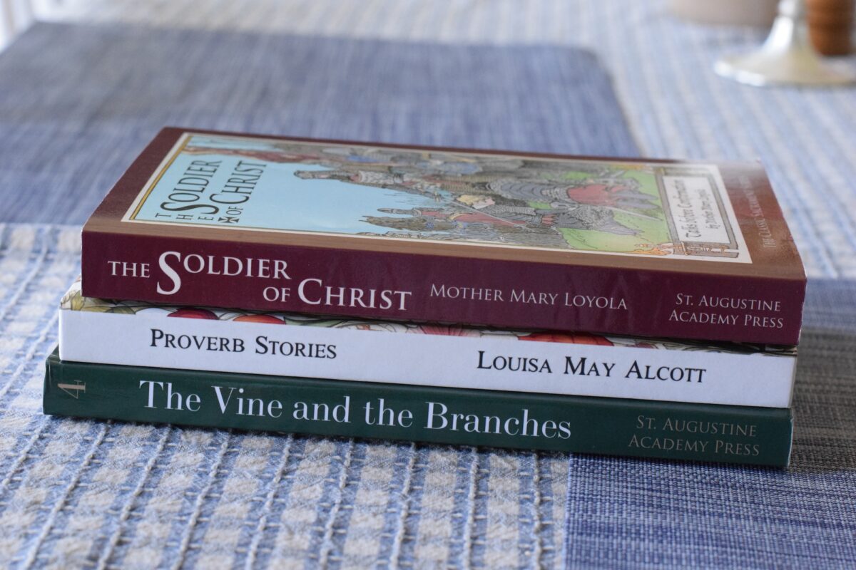 stack of catechism books for 4th grade on a table. 