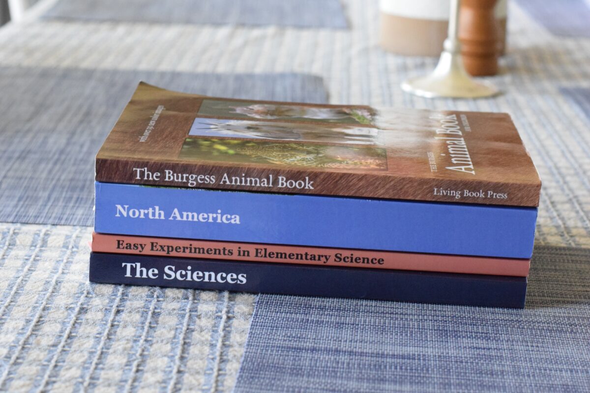 geography and natural history book stacked on a table. 
