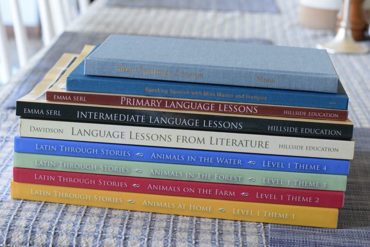 language arts and latin books stacked on a table. 