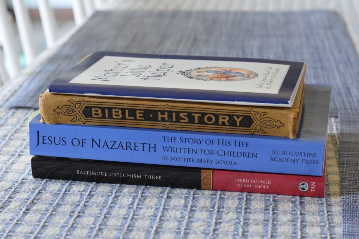 stack of 6th grade catechism books on a table. 