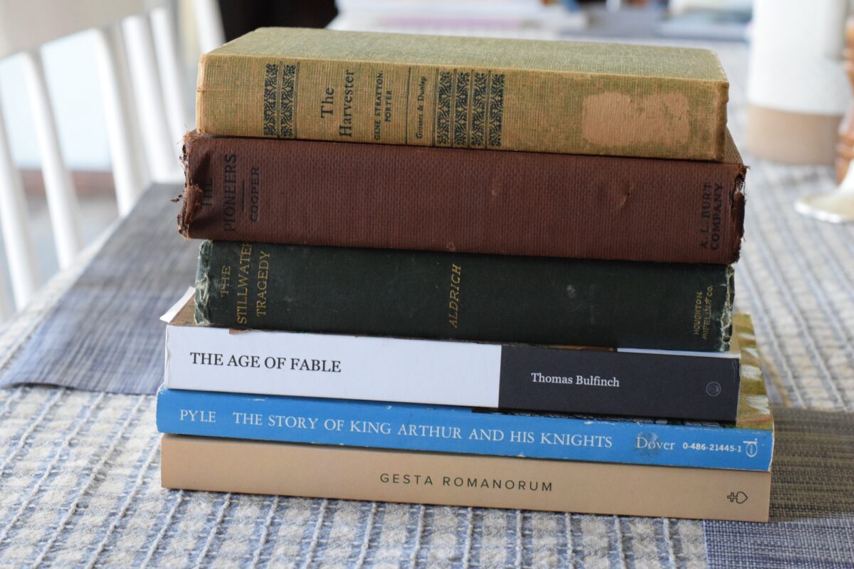 year 6 myths and legends book stack on a dining table. 