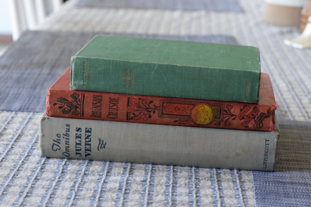 year 6 adventure story books stacked on a table. 